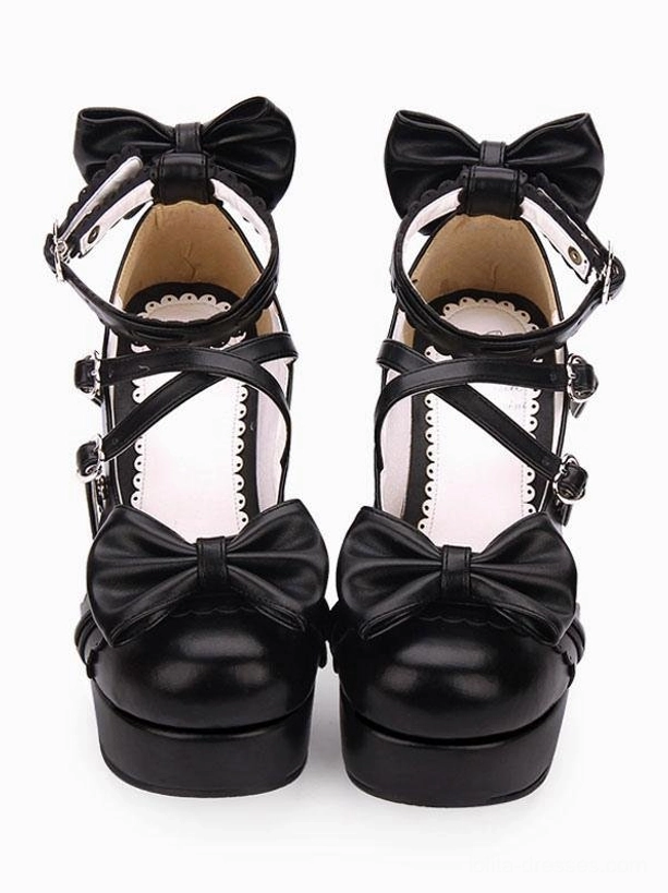 Black matte lolita platform shoes with crisscross ankle straps bow accents heart-shaped buckles chunky heel frontal paired view