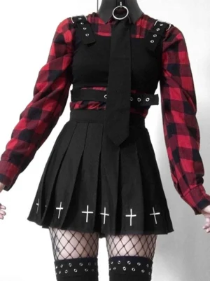 Black gothic pleated mini skirt displayed on mannequin with plaid top and chain belt, front studio view showing full pleated A-line silhouette