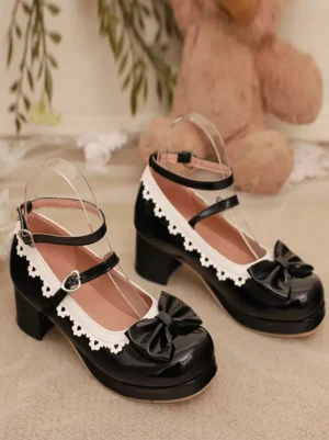 Black glossy lolita pumps with ankle strap and front bow flat lay product display with teddy bear and plants
