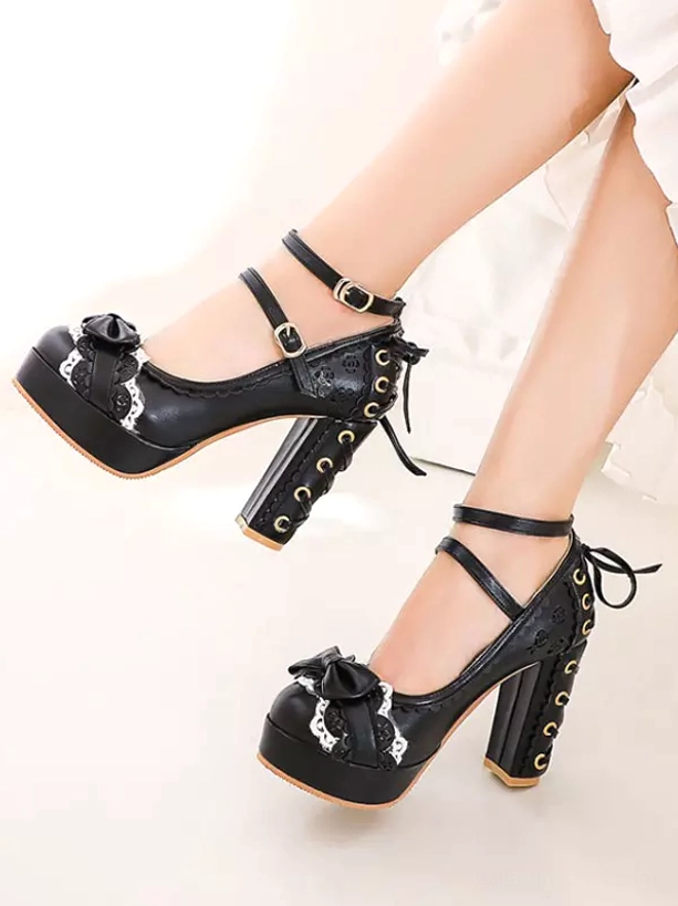 Black lolita pumps front-side angle showing back lace-up decoration, bow toe detail, and ankle strap with white skirt styling