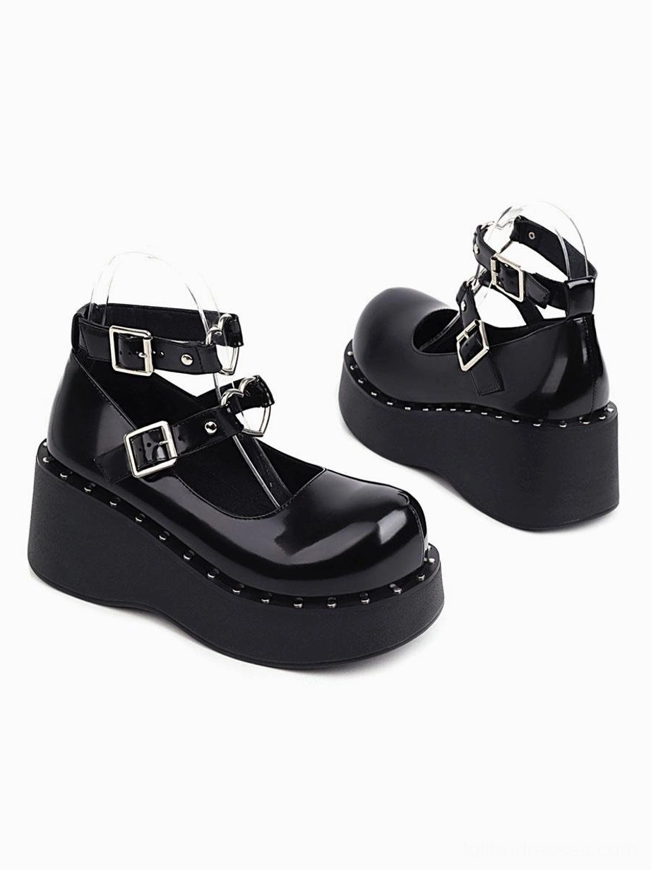 Black patent leather academic lolita shoes side rear paired view showing t-strap buckle design rounded toe studded sole edge