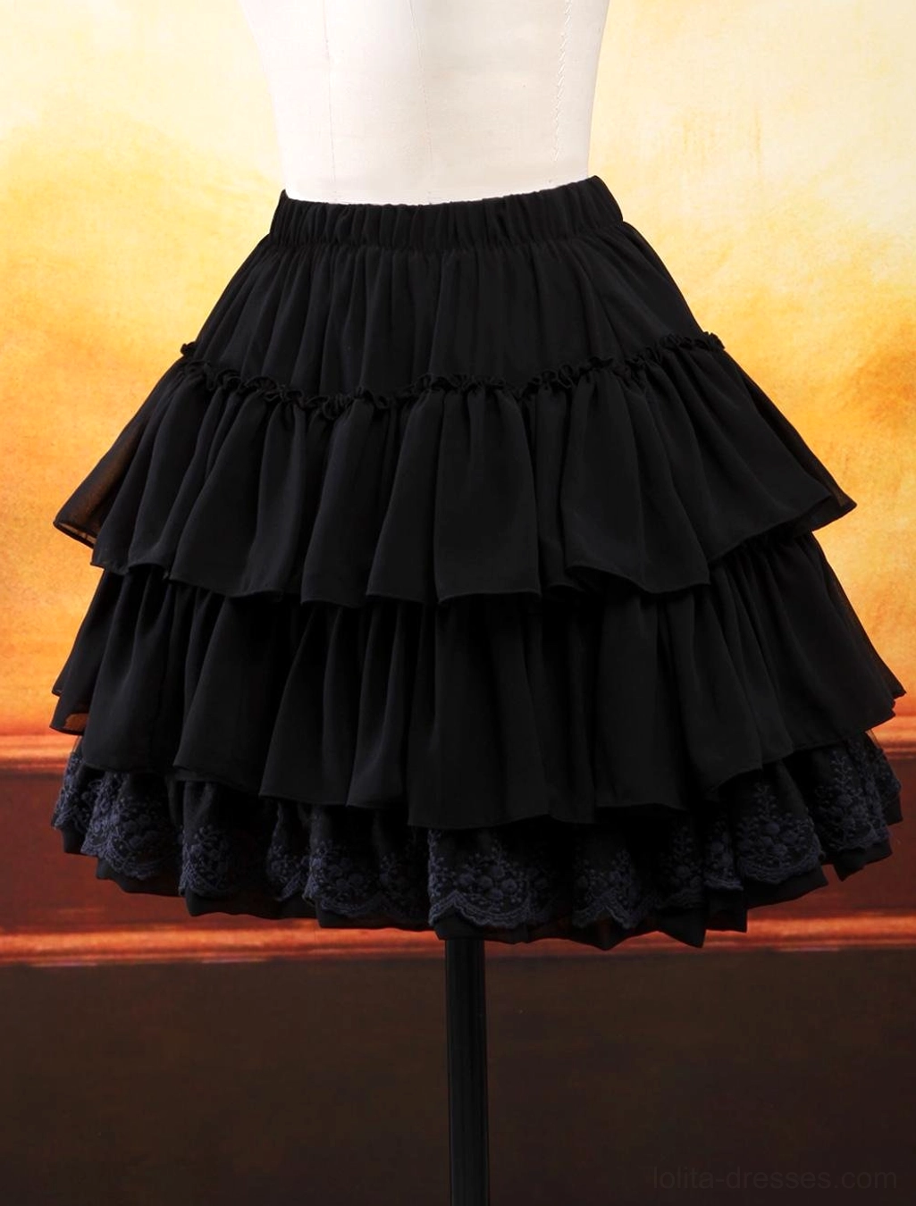 Black chiffon lolita skirt featuring layered ruffles and dark lace hem detail shown in three-quarter front angle on dress form highlighting ruffle construction