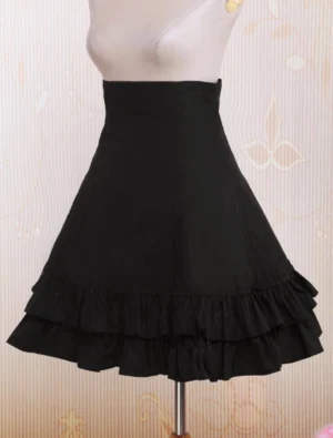 Black gothic lolita skirt front center view on mannequin displaying double-layer ruffled hem and high-waist silhouette with structured shape