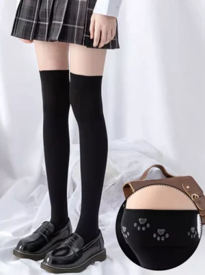 Black lolita socks close-up cuff showing paw-shaped anti-slip silicone dots secure fit design over-the-knee length