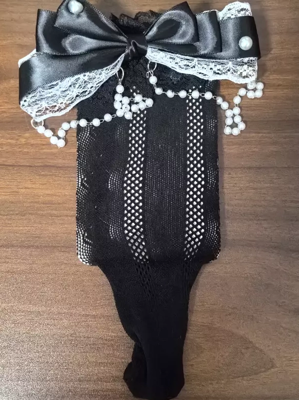 Black lolita decorative socks with vertical hollow mesh black satin bow white lace ruffle and pearl tassel flat lay view