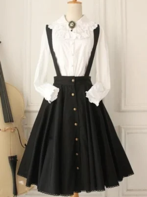 Black Lolita suspender salopette dress front full view showing gold buttons scalloped hem ruffled blouse cuffs and refined structured silhouette