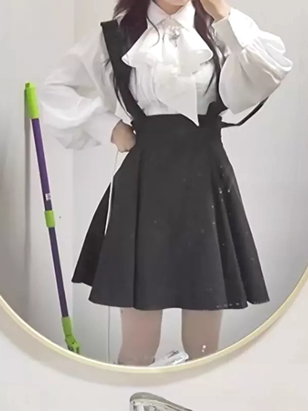 Black lolita suspender skirt outfit worn by female model in mirror selfie showing glittery flared silhouette
