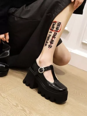 Black lolita pumps side profile showcasing T-bar buckle strap and chunky platform wedge heel sole structure
