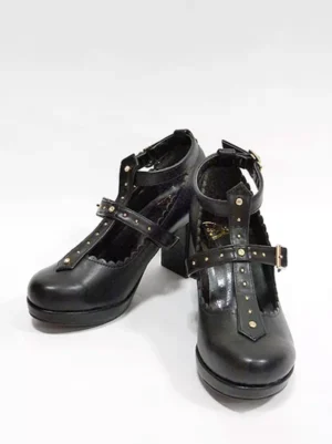 Black lolita t-strap pumps with metal rivet decorations and scalloped ankle strap, paired three-quarter front view showcasing chunky heel and round toe design
