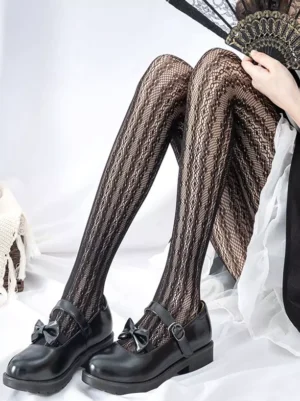 Black lolita mesh tights side seated view with folding fan accessory and maid costume detail