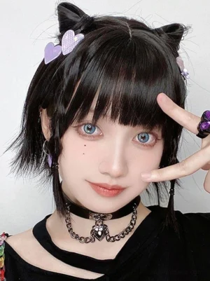 Black lolita wig styled with cat ear hairpins and heart-shaped clips, braided hair sections, goth accessories detail, lolita tea party styling inspiration