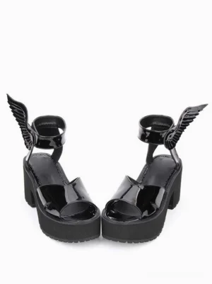 Pair of black Lolita wing platform sandals rear side view displaying thick platform sole, open toe design, sculptural ankle wing ornaments, and robust block heel construction