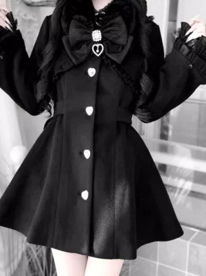 Black Lolita winter coat close-up detail showing fitted waist, heart-shaped front buttons, ruffled lace cuffs, and upper torso