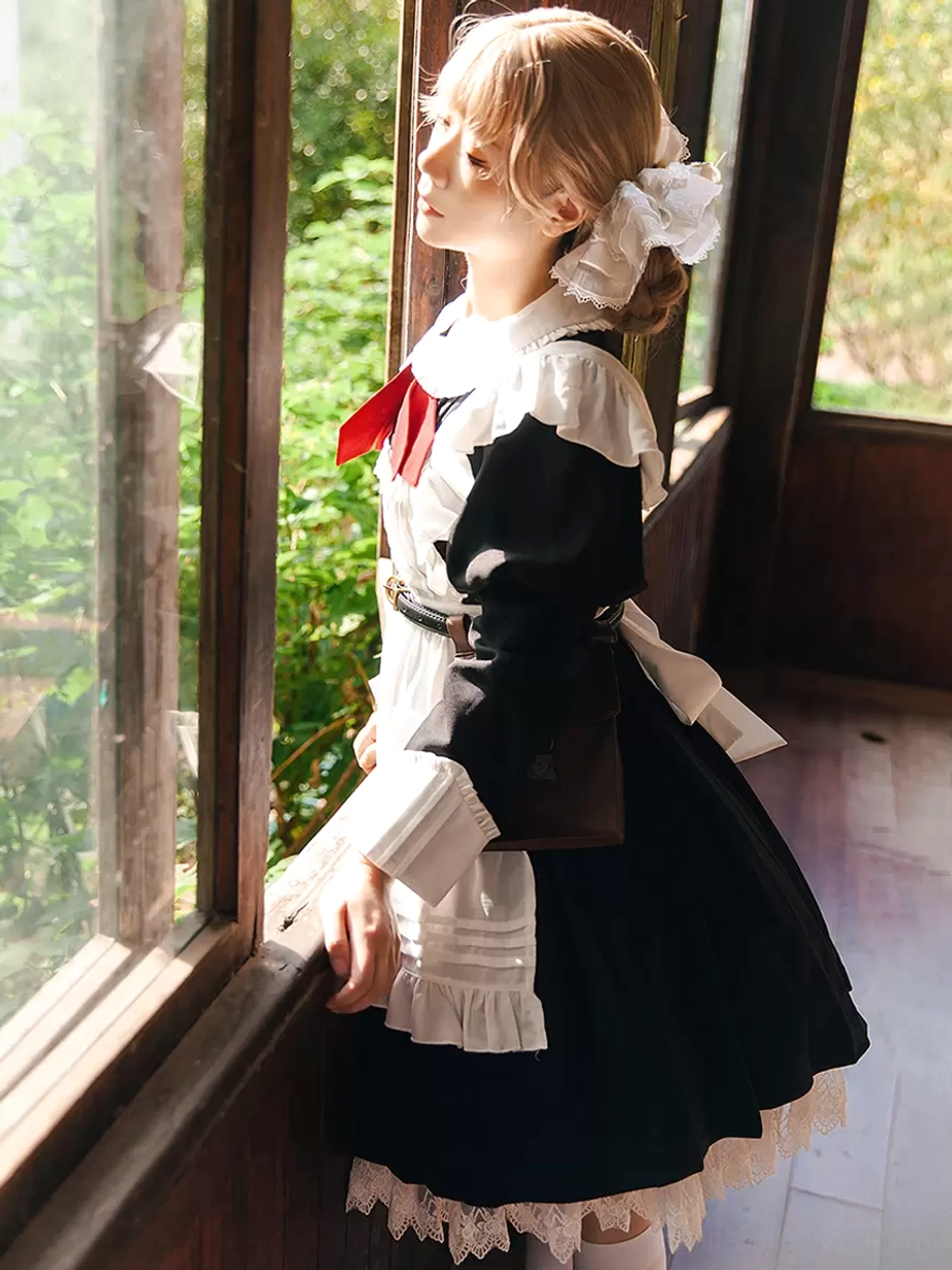 Additional styling detail of classic long-sleeve black lolita dress showing knotted embellishment, structured silhouette, and traditional lolita proportions