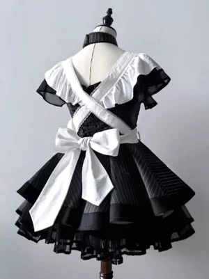 Black maid gothic lolita dress back view showing crisscross straps large white bow striped tulle tiered skirt on dress form