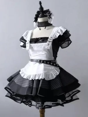 Black maid gothic lolita dress front view flat lay with tiered apron ruffles lace trim heart buckle and white bow choker on dress form