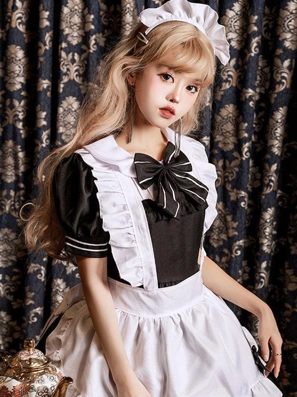 Black gothic maid lolita dress close-up upper body featuring large oversized bow, ruffled sleeve cuffs and matching maid headband detail