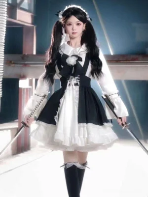 Black maid lolita dress full front view with twin-tailed model wearing double ruffle skirt, white lace apron, and peter pan collar in industrial setting