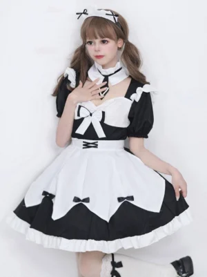 Black maid lolita dress with ruffled apron and bow details front view on model with twin-tails hairstyle