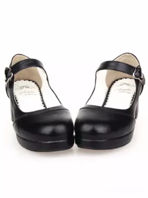 Black Mary Jane Lolita heels with heart-shaped buckle ankle strap, round toe, matte black PU leather, front flat view showing lace-edged insole detail