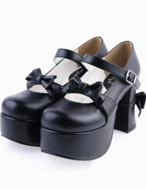 Black matte lolita Mary Jane platform heels with decorative bow and ankle strap buckle shown from side-front angle displaying both shoes
