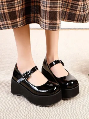 Black patent leather Mary Jane platform pumps front view with round toe and adjustable ankle strap buckle worn with plaid midi skirt for academic lolita outfit
