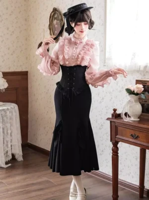Black mermaid fishtail gothic lolita skirt with high waist corset and jacquard lace detail, styled with pink long-sleeve blouse in three-quarter front view