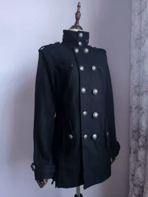 Black military officer winter coat with double-breasted metal buttons and stand collar, front three-quarter view on model, lolita-inspired structured silhouette with long sleeves and shoulder epaulets