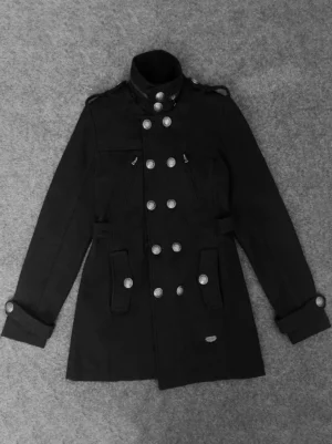 Black military coat flat lay overhead view showing long sleeves, belt loops, functional zippered side pockets, and embossed button details on polyester fabric