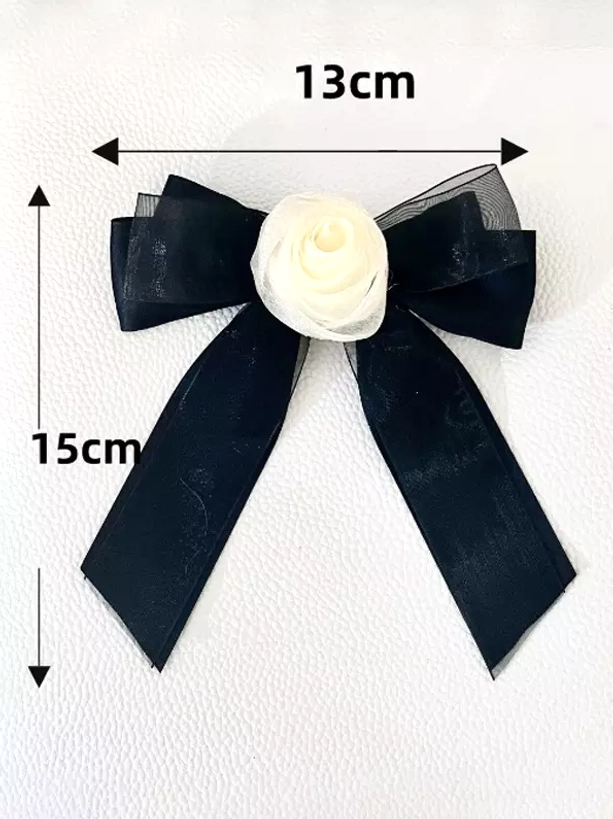 Black sheer organza bow hair clip with cream rose decoration flat lay front view on white leather background, showing 13x15cm dimensions of sweet lolita accessory