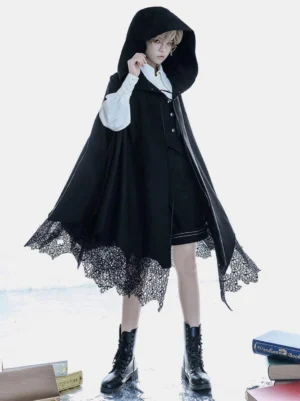 Gothic Ouji hooded poncho cape styled over white blouse and waistcoat showing androgynous fashion coordination