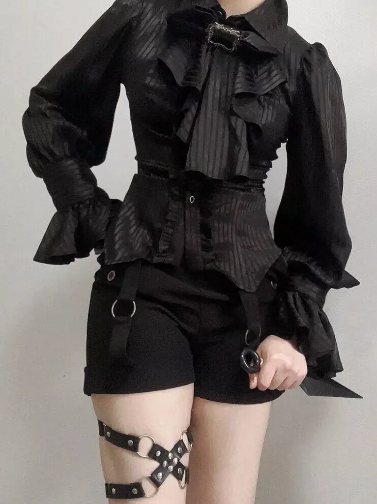 Black Ouji lolita high-waist shorts with D-rings metal decorations and ruffled gothic blouse, front view on model with leather harness