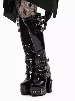 Black patent Gothic Lolita platform boots side front view showing aligned upper calf buckle strap placement and thick platform heel construction with grommet details