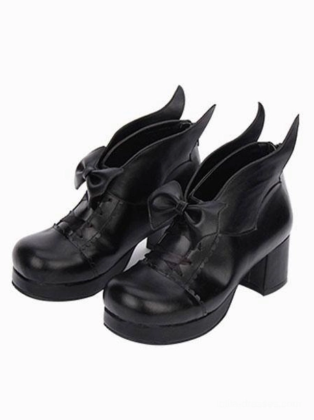 Pair of black patent leather Gothic Lolita chunky heel pumps with bow decoration, front-side view featuring polished finish and round block heel design