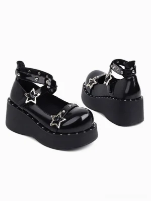 Matching black lolita platform shoes side three-quarter view showing glossy round toe cap and dual star decorations with studded trims
