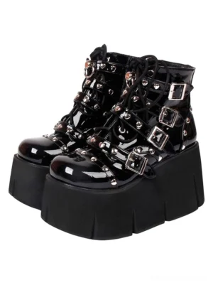 Black patent leather Lolita platform boots front three-quarter view showing silver studded buckle straps chunky wedge heel thick sole