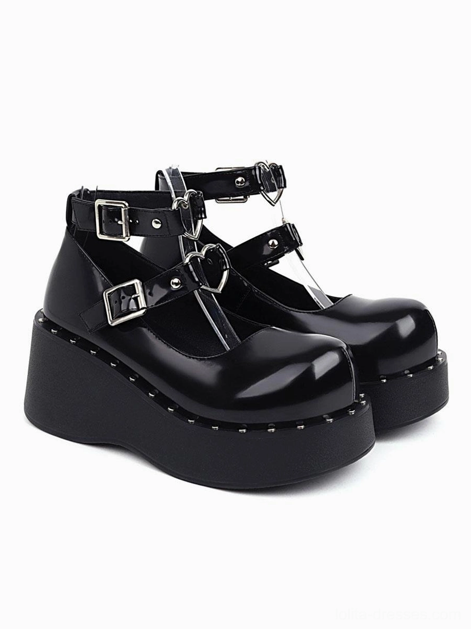 Black patent leather wedge heel academic lolita shoes three-quarter front paired view with dual ankle buckles and studded platform