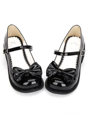 black patent leather lolita mary jane shoes with front bow detail front flat lay view on white background showing round toe and buckle ankle strap