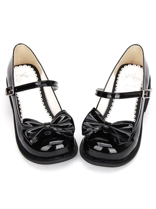 black patent leather lolita mary jane shoes with front bow detail front flat lay view on white background showing round toe and buckle ankle strap