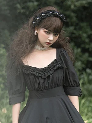 Black lolita headdress with faux pearl embellishments pleated satin base front view model in black dress forest background