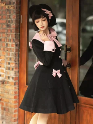 Black pink lolita overcoat three-quarter angle showing A-line flared skirt silhouette back bow decorations and pocket bows on model at wooden door