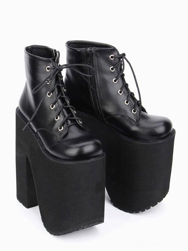 Black platform short boots side profile flat lay matte black thick sole rounded toe cap lace-up front design