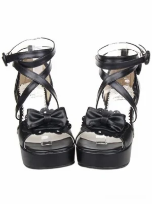 Black lolita platform sandals front view with chunky block heel, peep toe bow ornament, and cross ankle straps on white background