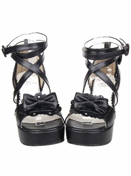Black lolita platform sandals front view with chunky block heel, peep toe bow ornament, and cross ankle straps on white background