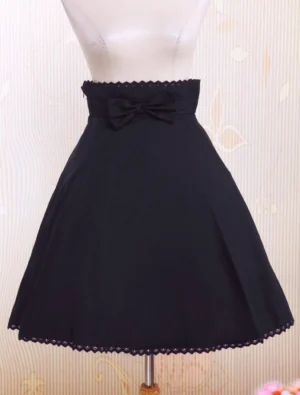 Black pleated high-waisted lolita skirt front view with decorative fabric bow and scalloped lace hem, authentic gothic lolita fashion style