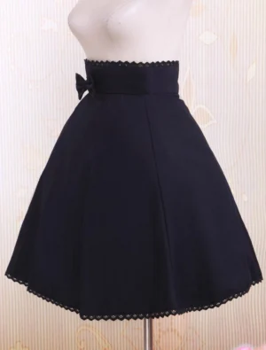 Black pleated lolita skirt side profile showing a-line silhouette, side fabric bow detail, and scalloped lace trimming on hem