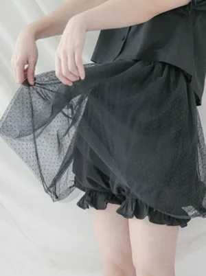 Black lolita bloomer shorts with polka dot tulle overlay side view on model showing ruffled hem details and elastic waistband