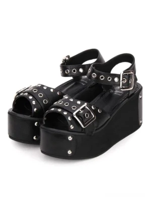 Black punk lolita platform sandals with metallic rivets and grommets front three-quarter view showing dual buckle strap design and thick wedge sole