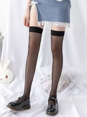 Black sheer lolita thigh-high socks featuring semi-transparent mesh construction with solid black cuff, coordinated with blue lace skirt and Mary Jane shoes for gothic lolita aesthetic