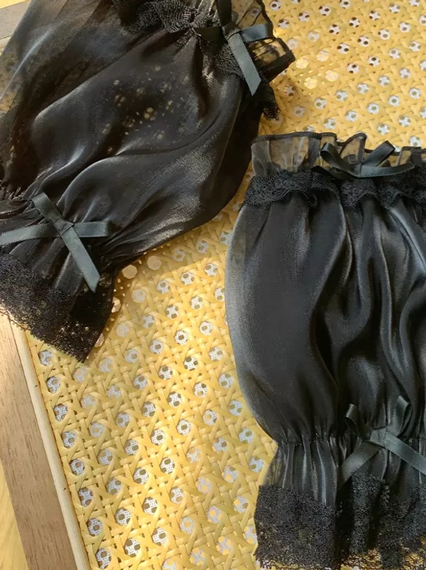 Black sheer organza puff oversleeves with black lace hem and black satin bow accents, edgy Sweet Lolita aesthetic